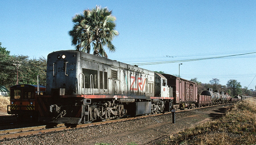 Zambia Railways type U20C Co-Co diesel-electric locomotive no. 0.019 near Victoria Falls station with a freight train from Zambia