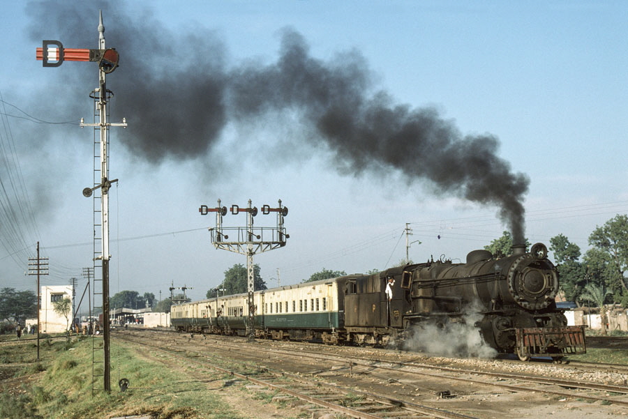 Class YD 2-8-2 steam locomotive & train departs Mirpur Khas station, Pakistan