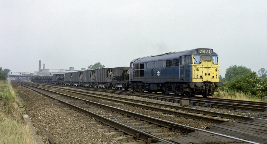 Class 31 A1A-A1A diesel locomotive no. 31149 with a train of ballast wagons heads south on the Midland Main Line, Loughborough, 9/7/75.