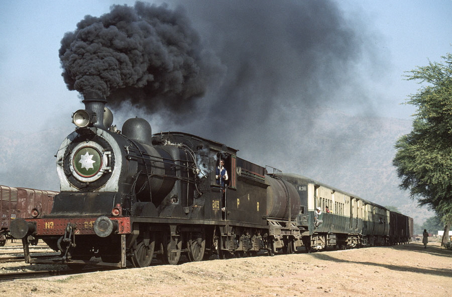 Broad gauge, oil fired, steam locomotive on a passenger train departing Gharibwal, Pakistan, 21st December 1993