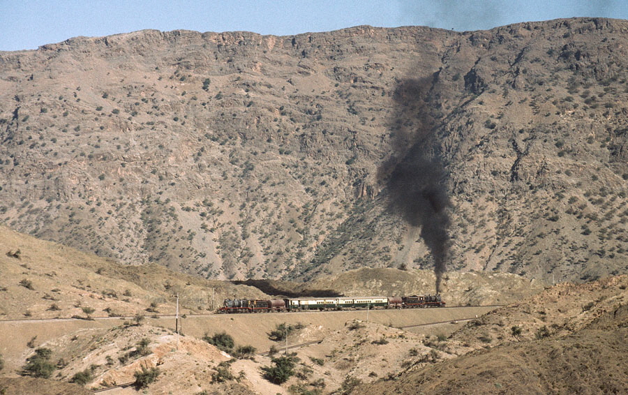 Broad gauge, oil fired class HGS 2-8-0 steam locomotives power a charter train up the Khyber Pass, 23rd December 1993.