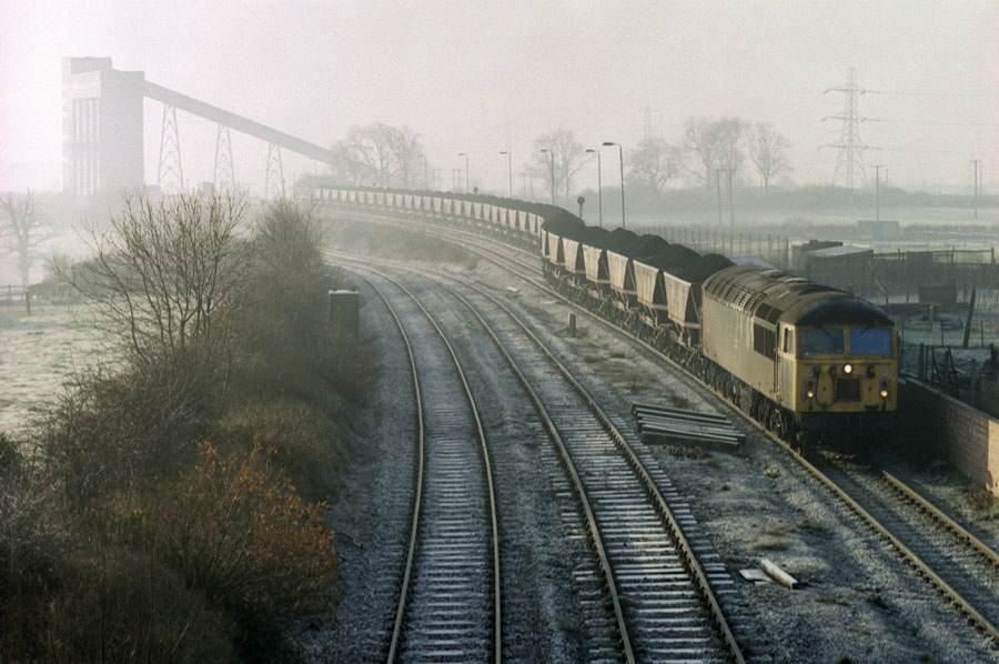 Class 56 Co-Co diesel locomotive no. 56066 departs with a lengthy coal train from the rapid coal loader at Bagworth, Leicestershire