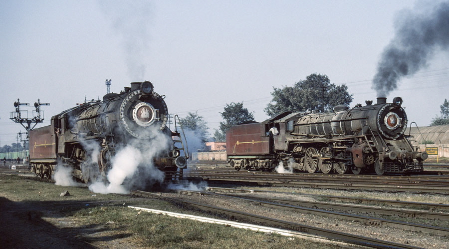 Broad gauge, class WL 4-6-2, steam locomotives prepare to head from the locomotive shed into Jalandhar station, India, to power local passenger trains, 25th December 1993
