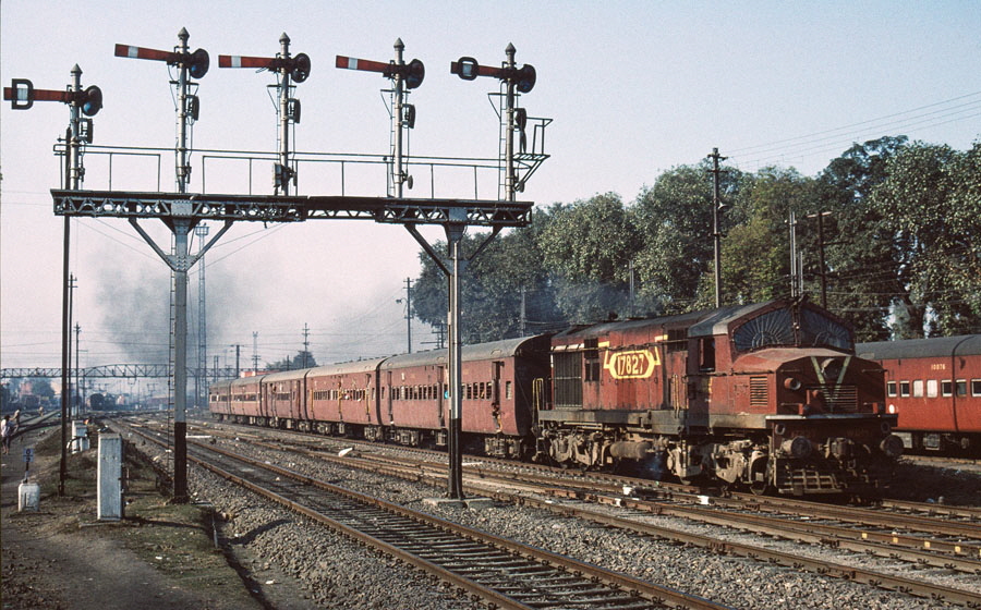 Broad gauge, diesel locomotive, class WDM2 Co-Co 17827 departs from Jalandhar, India, with a local passenger train, 25th December 1993.