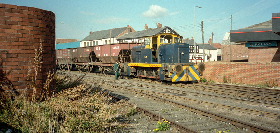 Seaham Harbour Co. 0-6-0 diesel shunting locomotive with coal train next to the crossing over North Terrace, Seaham harbour