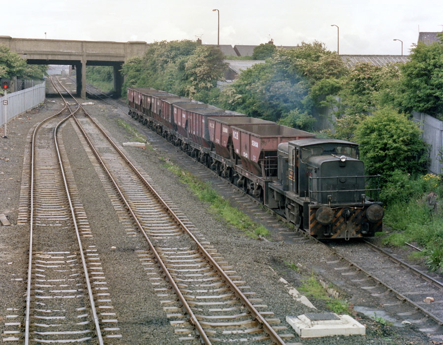 NCB 0-6-0 diesel locomotive no. 20-110-704 starts down the incline from Seaham colliery towards Seaham harbour with a train of wagons loaded with coal or spoil