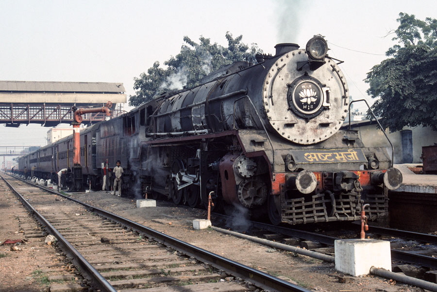 Broad gauge, class WG 2-8-2 10491, takes water while on a passenger train at Bareilly Junction station, India, 27th December 1993