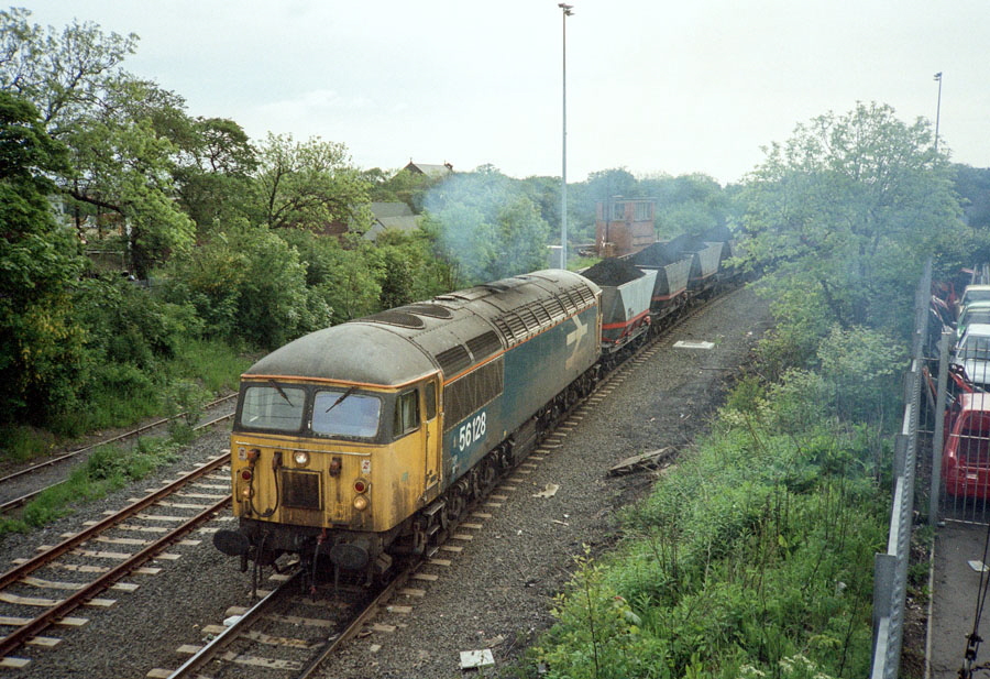 Class 56 Co-Co diesel locomotive no. 56128 propels the loaded coal train onto the British Rail Seaham to Sunderland line