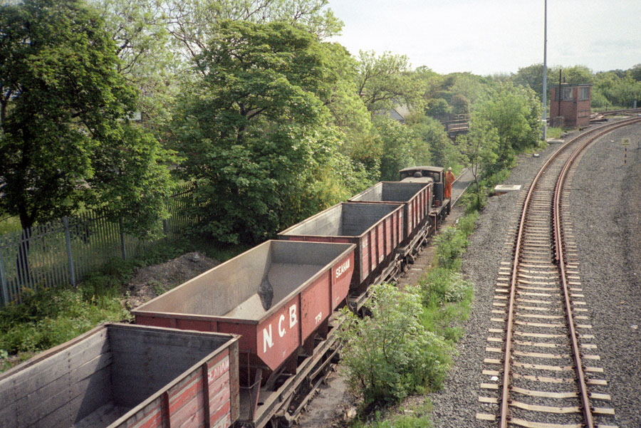 NCB 0-6-0 diesel locomotive propels a train of empty coal wagons up the incline from Seaham harbour to Seaham colliery