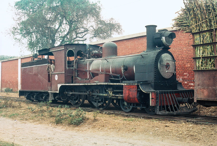 Metre gauge 4-4-0 no. 5, built by Vulcan Foundry in 1884, at Saraya Sugar Mills, India, with a load of sugar cane from the fields, 28th December 1993
