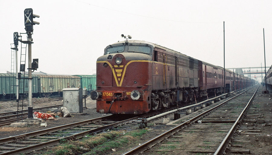 Broad gauge diesel locomotive, class WDM1 Co-Co no. 17045, built by Alco in 1958, stands with an evening train at Gorakhpur station, India, 28th December 1993