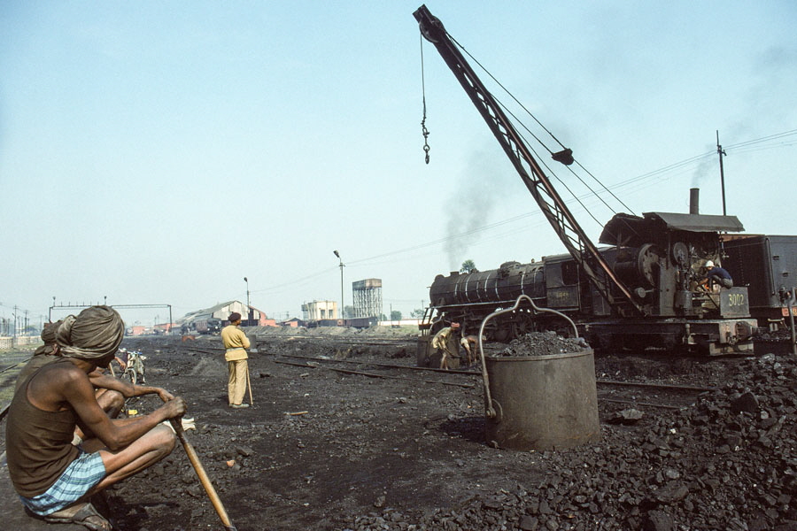 Labourers and steam crane coaling a locomotive at Samastipur locomotive shed, India, 29th December 1993