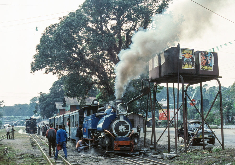 Darjeeling Himalayan Railway narrow gauge steam locomotive, class B 0-4-0ST no. 795 takes water at Sukna before continuing to Darjeeling with a passenger train, India,