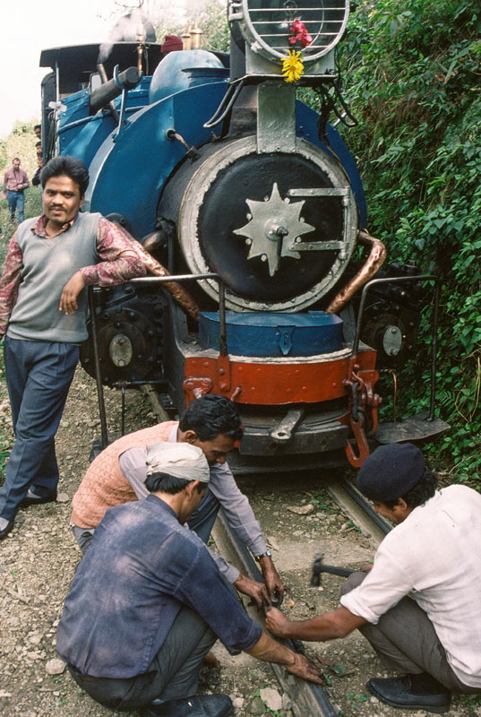 Darjeeling Himalayan Railway narrow gauge steam locomotive, class B 0-4-0ST no. 795 receiving repairs while heading up the mountain to Darjeeling with a passenger train, India,