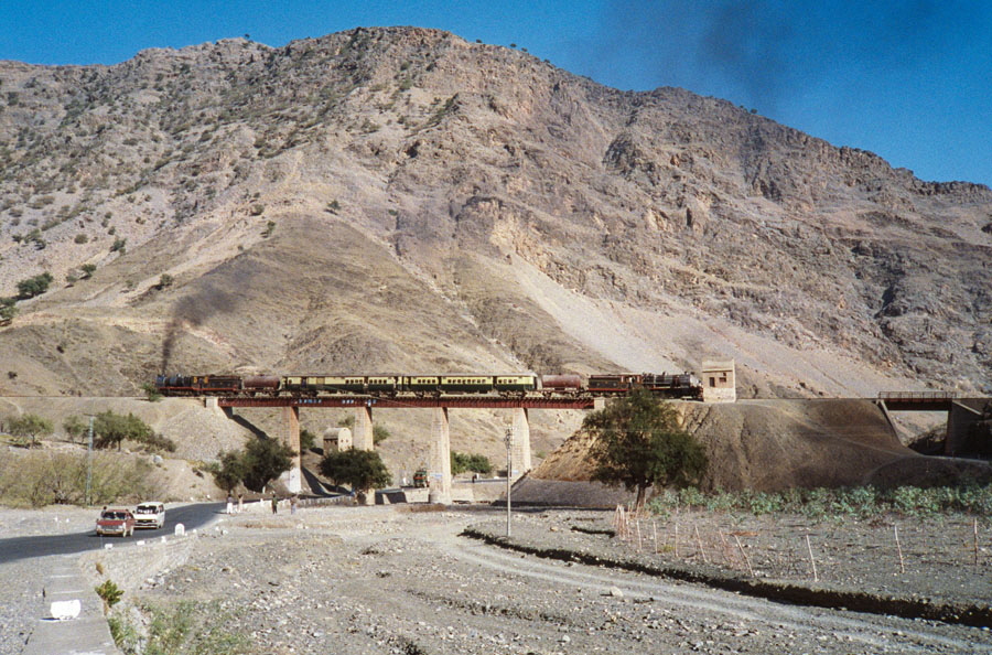 Broad gauge, oil fired class HGS 2-8-0 steam locomotives start to climb up the Khyber Pass with a charter train, 23rd December 1993
